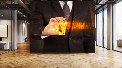 Businessman holding lightbulb with COMPUTER TECHNOLOGY inscription, Business technology concept Wall mural