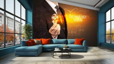 Businessman holding lightbulb with TECHNOLOGY VISION inscription, Business technology concept Wall mural