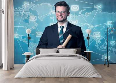 Businessman holding tool with global map graphic on the background Wall mural