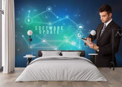 Businessman in front of cloud service icons with SOFTWARE UPDATE inscription, modern technology concept Wall mural