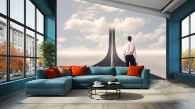 Businessman looking at 3d road that goes up in the sky Wall mural