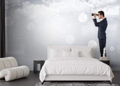 Businessman  looking forward with binoculars Wall mural