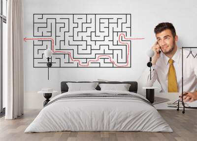 Businessman presenting a maze on a wall Wall mural