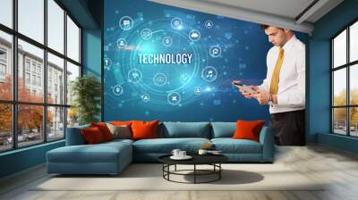 Businessman thinking about modern technology Wall mural