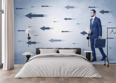 Businessman walking with arrows on the background and briefcase on his hand
 Wall mural