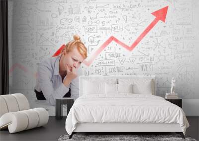 Businesswoman sitting at table with market diagrams Wall mural