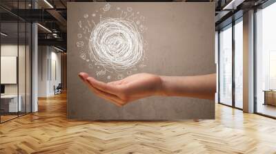 Chaos concept in the hand of a woman Wall mural