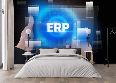 Close-up of a hand holding tablet with ERP abbreviation, modern technology concept Wall mural