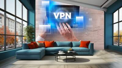 Close-up of a hand holding tablet with VPN abbreviation, modern technology concept Wall mural