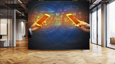 Close up of two smartphones syncing business data Wall mural