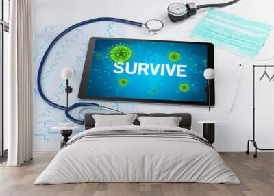 Close-up view of a tablet pc with SURVIVE inscription, microbiology concept Wall mural