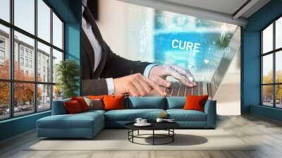 Doctor working a health check with CURE inscription, recording medical test results Wall mural