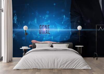 Elegant hand holding GONE VIRAL inscription, social networking concept Wall mural