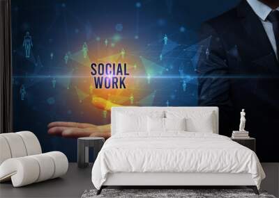 Elegant hand holding SOCIAL WORK inscription, social networking concept Wall mural