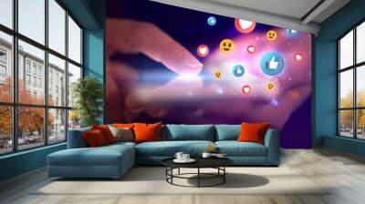 Finger touching phone with social media concept and dark background Wall mural