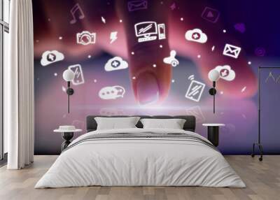 Finger touching tablet with white drawn application icons and dark background
 Wall mural