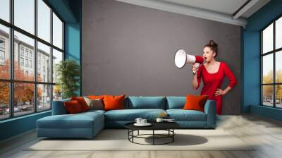 girl shouting into megaphone on copy space background Wall mural