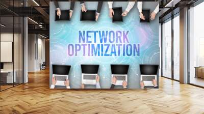 Group of people in front of a laptop with NETWORK OPTIMIZATION insciption, web security concept Wall mural