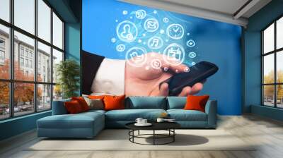 Hand holding smartphone with mobile app choices Wall mural