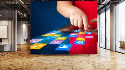 Hand holding tablet device with media application Wall mural