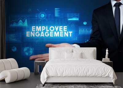 Hand of Businessman holding EMPLOYEE ENGAGEMENT inscription, business success concept Wall mural