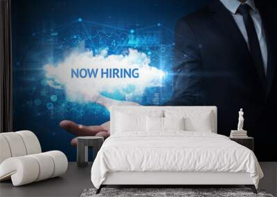 Hand of Businessman holding NOW HIRING inscription, successful business concept Wall mural