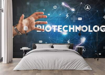 Hand pointing at BIOTECHNOLOGY inscription, modern technology concept Wall mural