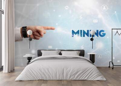 Hand pointing at MINING inscription, modern technology concept Wall mural