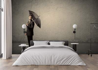 Handsome business man holding umbrella with copy space backgroun Wall mural