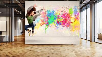 Happy teenager jumping with colorful ink splatter on urban backg Wall mural