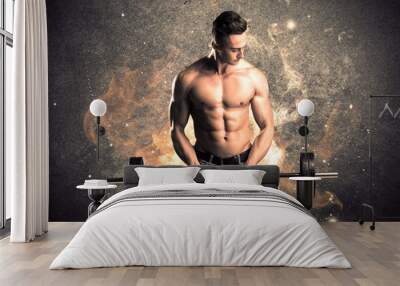 Healthy hot male showing muscles with fire Wall mural