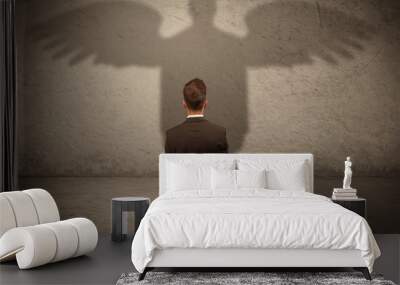 Honest salesman with angel shadow concept Wall mural