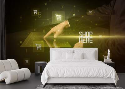 Online shopping with SHOP HERE inscription concept, with shopping cart icons Wall mural