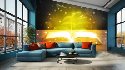 Open book with golden glow flying paper pages Wall mural