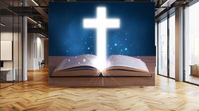 Open holy bible with glowing cross in the middle Wall mural