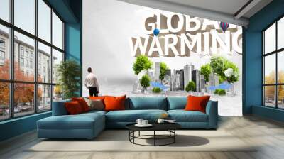 Rear view of a businessman standing in front of GLOBAL WARMING inscription, Environmental protection concept Wall mural