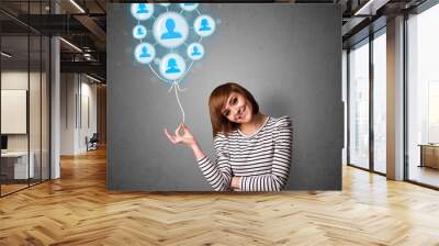 Woman holding social network balloon Wall mural