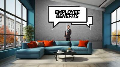 Young business person in casual holding road sign with EMPLOYEE BENEFITS inscription, new business idea concept Wall mural