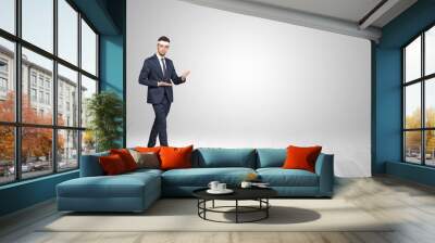 Young businessman in suit fighting in an empty space Wall mural