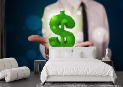 Young businessman presenting green glowing dollar sign Wall mural