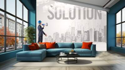 Young businessman with hard hat and SOLUTION inscription, new business opportunity concept Wall mural