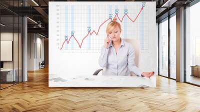 Young businesswoman calculating stock market with rising graph i Wall mural