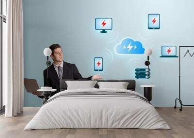 young man holding a laptop and presenting cloud computing networ Wall mural