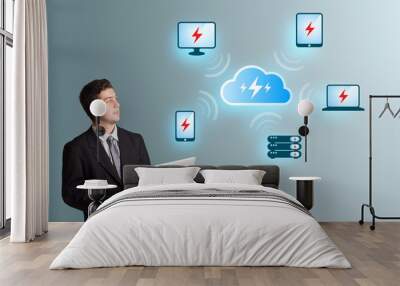 young man holding a laptop and presenting cloud computing networ Wall mural