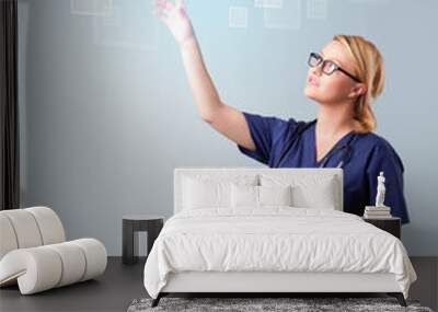 Young nurse pressing modern medical type of buttons Wall mural