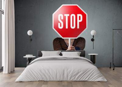 Young woman holding a stop sign Wall mural