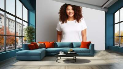 A young curly plus size model posing for a t-shirt mockup, wearing a blank , clean white shirt Wall mural