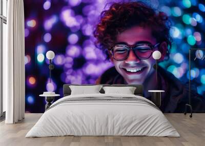 Young guy on his phone smiling at purple light Wall mural