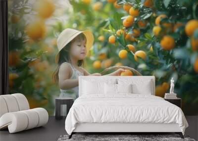 A cute child with basket and fresh orange fruit in plantation farm field Wall mural