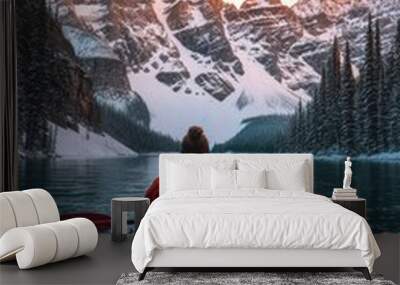 A person kayaking in lake water in winter with snow mountain at sunrise Wall mural